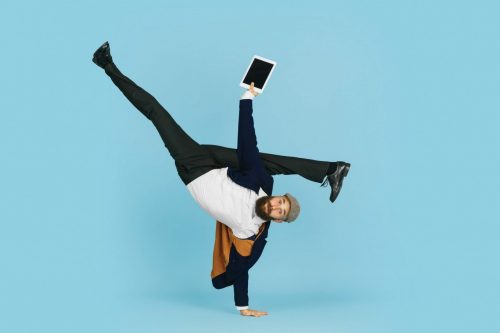 Young,Caucasian,Businessman,Having,Fun,Dancing,Break,Dance,On,Blue