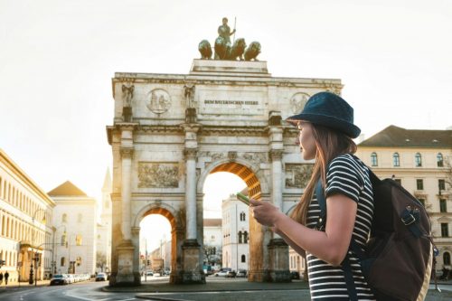 A,Tourist,Girl,With,A,Backpack,Looks,Sights,In,Munich